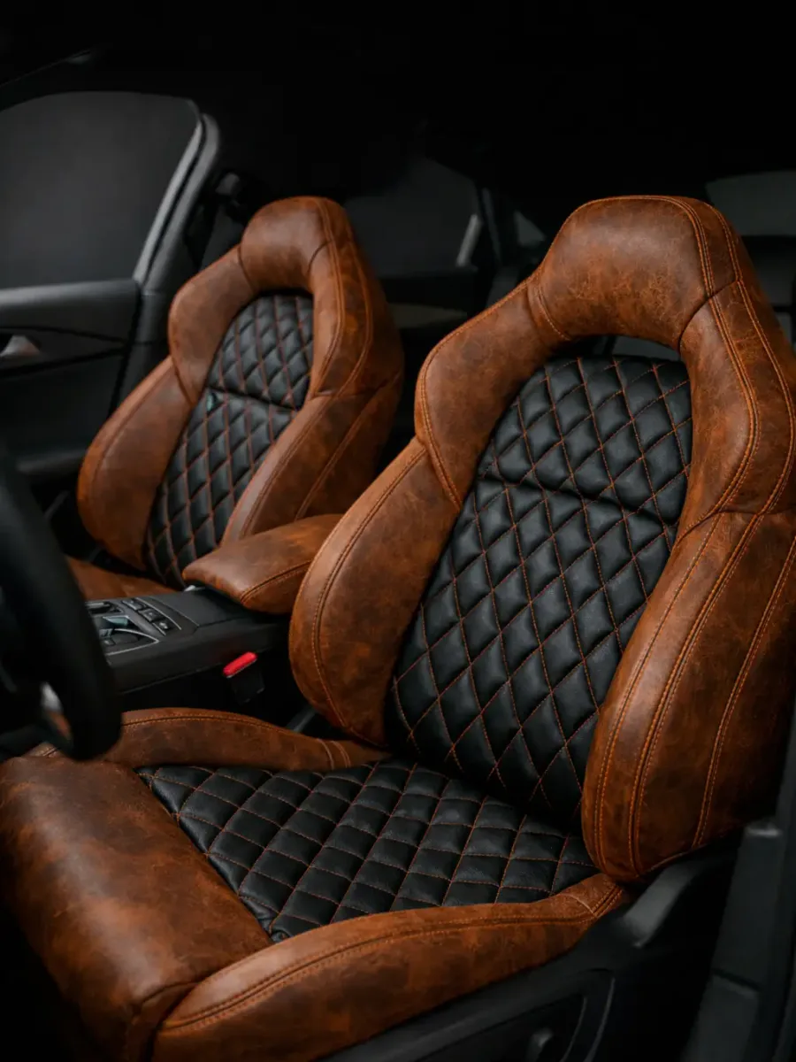 Custom brown leather sport seats with black diamond-stitched inserts and orange contrast stitching — BCAutowerx Mountain Home ID